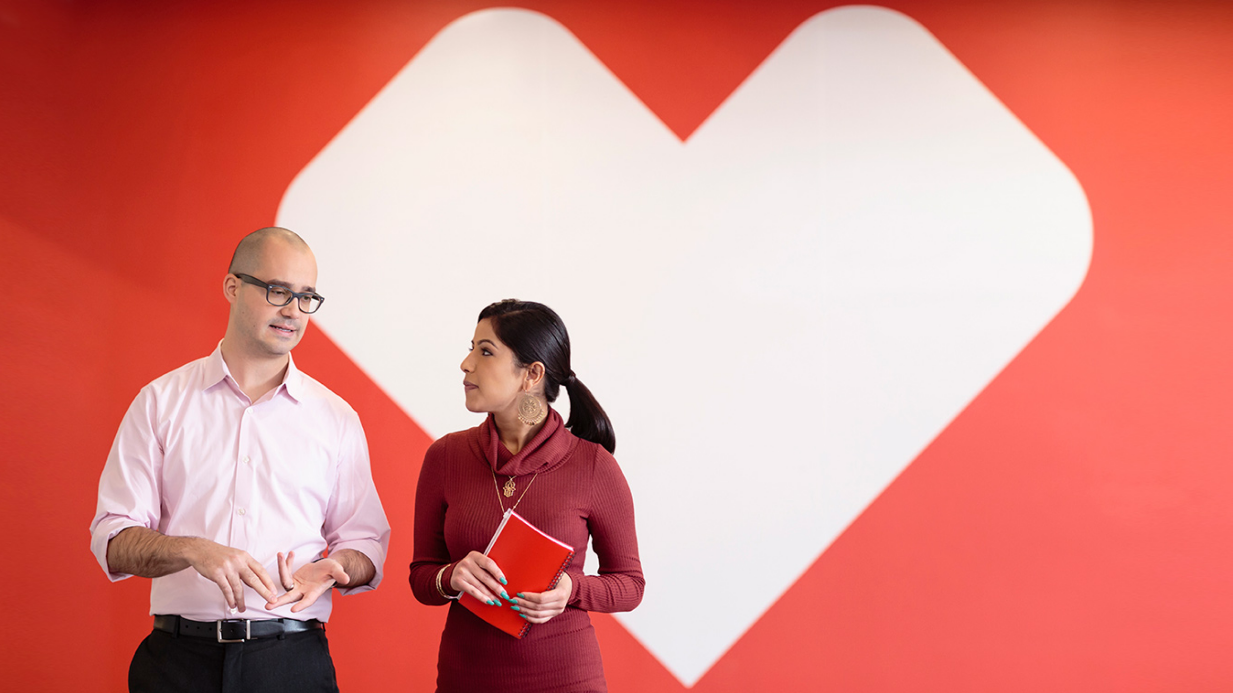 CVS colleagues in front of a white heart logo